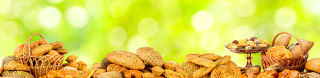 Wide panoramic photo bread products on natural green background.