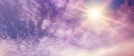 Fantastically beautiful sky in lilac tones and bright sun.の写真素材