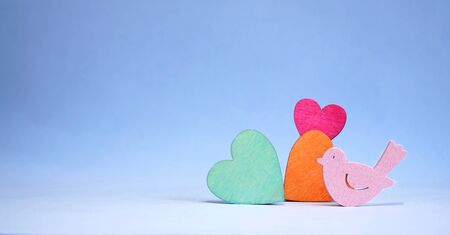 background blue with wooden hearts and birdの写真素材