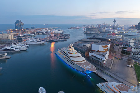 Barcelona, Spain; 05042020: Aerial view of the Russian superyacht, The Dilbar, owned by Russian billionaire Alisher Usmanov. At sunset with the port of Barcelona in the background horizontal viewのeditorial素材