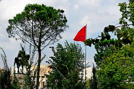 Flag of Albania with a black double-headed eagle in the central square of Skanderbeg in Tiranaの写真素材