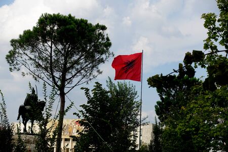 Flag of Albania with a black double-headed eagle in the central square of Skanderbeg in Tiranaの写真素材