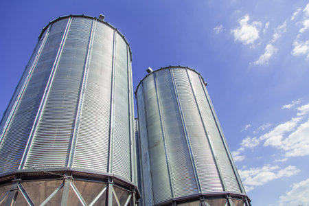 Background, metal barrels granaries on the sky backgroundの写真素材