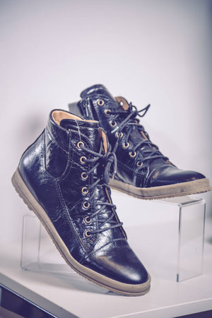 Black patent leather shoes lie on the shelfの写真素材