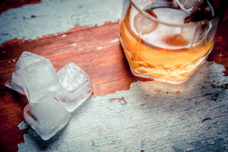 Vintage old photo of whiskey on a wooden rack with iceの写真素材