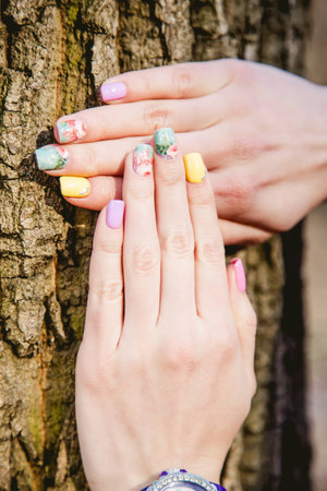 manicure on a background of tree barkの写真素材