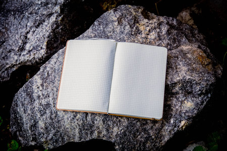 Entries in a notebook, net notebook on a granite stone aの写真素材