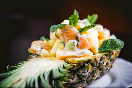 Dessert fruktovy salad in a plate of pineappleの写真素材
