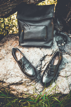 black leather shoes and a backpack, women's shoesの写真素材