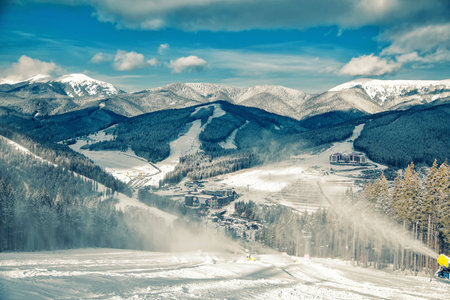 Snow cannon in the mountains, artificial snow skiingの写真素材