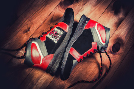 Red men's shoes on a wooden backgroundの写真素材