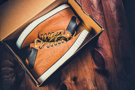 yellow men's shoes on a wooden backgroundの写真素材