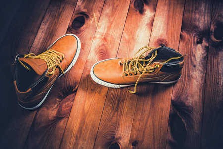 yellow men's shoes on a wooden backgroundの写真素材