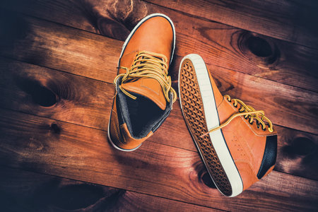 yellow men's shoes on a wooden backgroundの写真素材