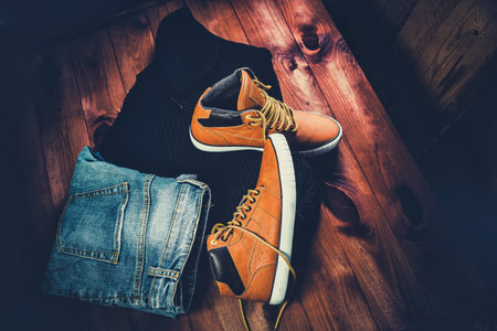 Men's Clothing yellow running shoes on a wooden background