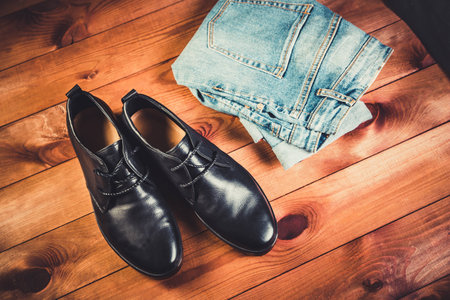 Black leather men's shoes on a wooden backgroundの写真素材