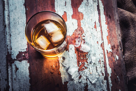 whiskey bottle and glass on a wooden vintage background