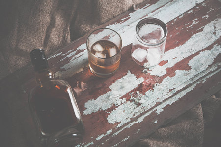 whiskey with ice, a bottle of rum tequila...の写真素材