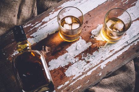 whiskey with ice, a bottle of rum tequila...