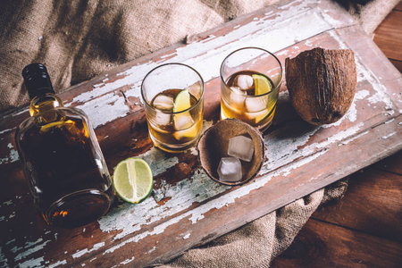 whiskey with ice, a bottle of rum tequila...の写真素材