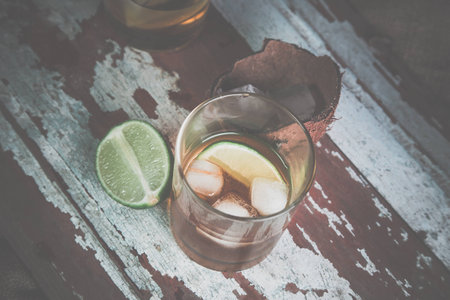 whiskey with ice, a bottle of rum tequila...の写真素材
