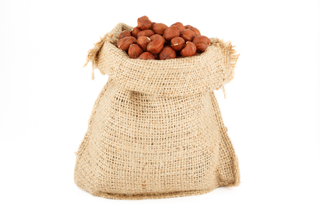 A linen sack is the filbert filled by nutsの写真素材