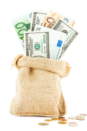 Money dollars and euros in the linen bag and coins scattered near isolated on white backgroundの写真素材