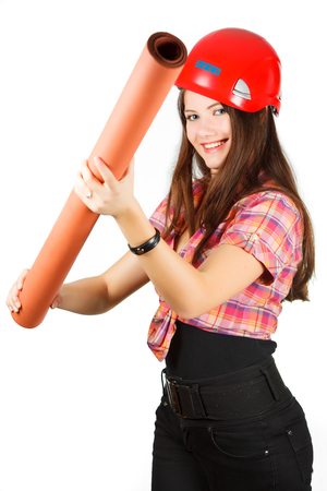 Girl in a helmet of the builder. Girl in a working form builder. Portrait isolated on white backgroundの写真素材