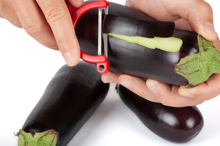 Eggplant isolated on white background. Fresh vegetables are cleaning by hands.の写真素材