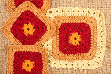 Knitted napkin on linen background. Hand made crocheted. Knitted napkin on linen background. Hand made crocheted.