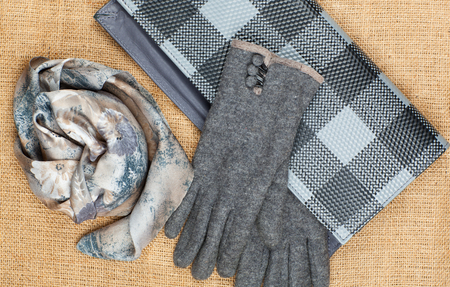 Scarf, handbag and gloves isolated on linen background. Female accessory .の写真素材