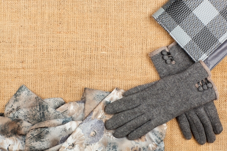 Scarf, handbag and gloves isolated on linen background. Female accessory .の写真素材