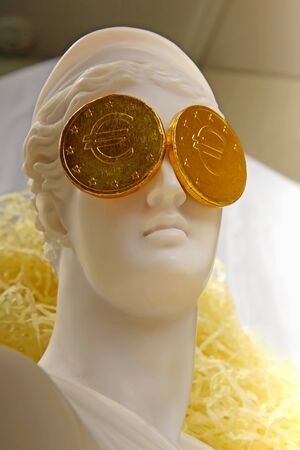 The Greek goddess Aphrodite with euro coins on the eyesの写真素材