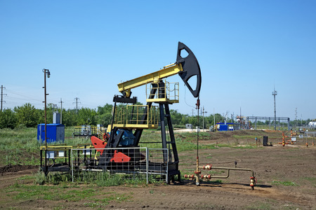 Work of oil pump jack on a oil fieldの写真素材