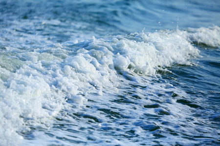 Blue sea with waves and foamの写真素材