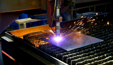 Industrial cnc plasma cutting of metal plate. Sparks fly. Closeupの写真素材