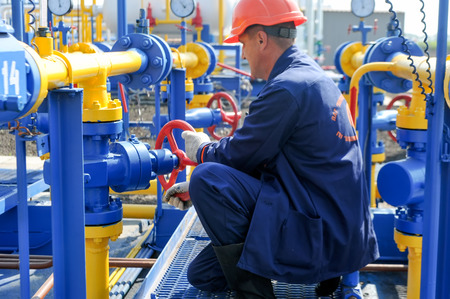 KHARKIV OBLAST, UKRAINE - AUGUST 11, 2015: Employee working on the gas treatment plant into operation at the oil and gas condensate depositのeditorial素材
