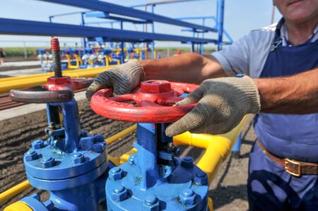 KHARKIV OBLAST, UKRAINE - AUGUST 11, 2015: Employee working on the gas treatment plant into operation at the oil and gas condensate depositのeditorial素材