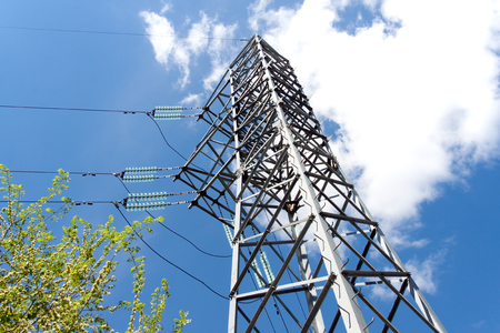 Electric pylon against the backdrop of the blue sky on a summer dayの写真素材