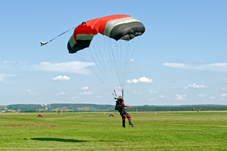 Paraglider landed after the jump at a bright sunny summer day. Active lifestyle, extreme hobbiesの写真素材