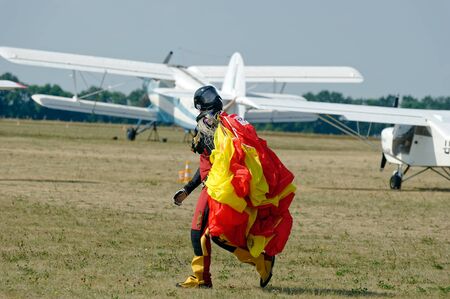 Kharkiv, Ukraine - August 26, 2017: Skydiver carries a parachute after landing at the airfield Korotych, Kharkov region, Ukraine on August 26, 2017のeditorial素材