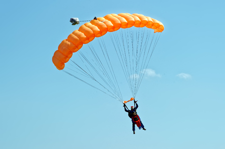 Kharkiv, Ukraine - August 20, 2016: Skydiver flying on orange parachute at the airfield Korotych, Kharkov region, Ukraine on August 20, 2016のeditorial素材