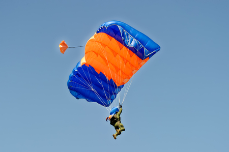 Kharkiv, Ukraine - August 20, 2016: Skydiver flying on colorful parachute at the airfield Korotych, Kharkov region, Ukraine on August 20, 2016のeditorial素材