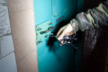 Kharkiv, Ukraine - October 26, 2017: The prison guard unlocks the camera door at the Kharkiv Penitentiary Facilityのeditorial素材