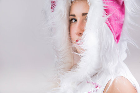 Close-up portrait of pretty girl in costume on light gray backgroundの写真素材