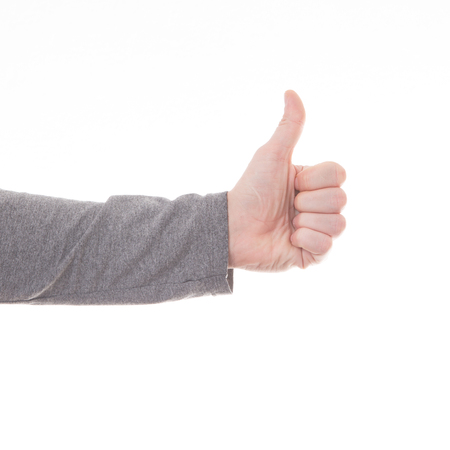 Man hand thumbs up sign isolated on white backgroundの写真素材