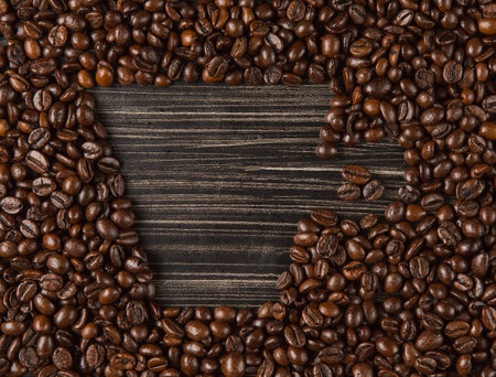 Copy space cup of coffee beans on dark backgroundの写真素材