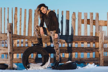 Military style portrait of cute lady on winter backgroundの写真素材