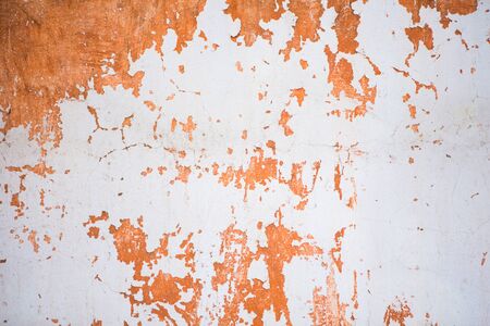 Background of old scratched white and orange wallの写真素材