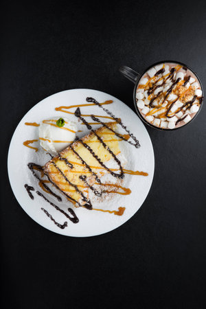 Image of coffee and cake on black tableの写真素材